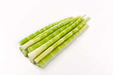 Peeled green bamboo shoots isolated on white background.