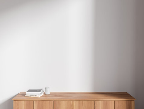 Dark wooden cabinet near white wall