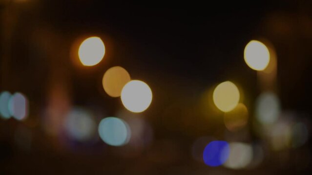 Blurred footage of transport. Blur of city lights along the road, out of focus light at night. Traffic on the road of the night city, beautiful background.