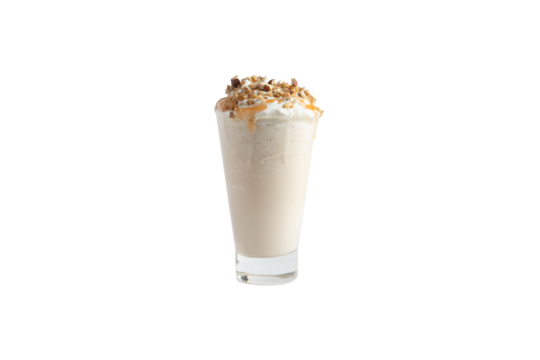 
Milkshake in a glass garnished with ground nuts. Transparent.