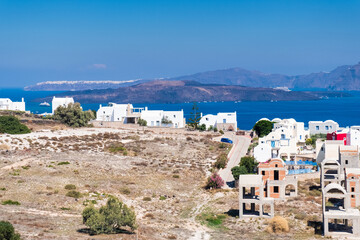 Fototapeta na wymiar View of the archipelago and island of Santorini in Greece with houses under construction.