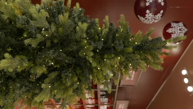 Vertical video of shopping mall Christmas tree decoration, interior, dolly out