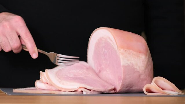 Tasting Prosciutto cotto with fork. Thin slices of meat. Slim slices of Spanish pork, leg, ham