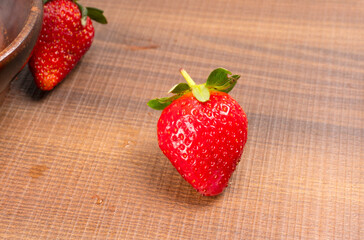 Fresh and Juicy beautiful organic strawberries on wooden background. Top view point.