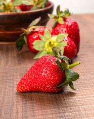 Fresh and Juicy beautiful organic strawberries on wooden background. Top view point.