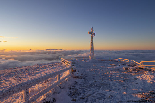 cross on the top of Tarnica in the Bieszczady Mountains on a frosty winter morning