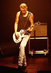 Its all for the music. A guitarist from a band playing on stage.