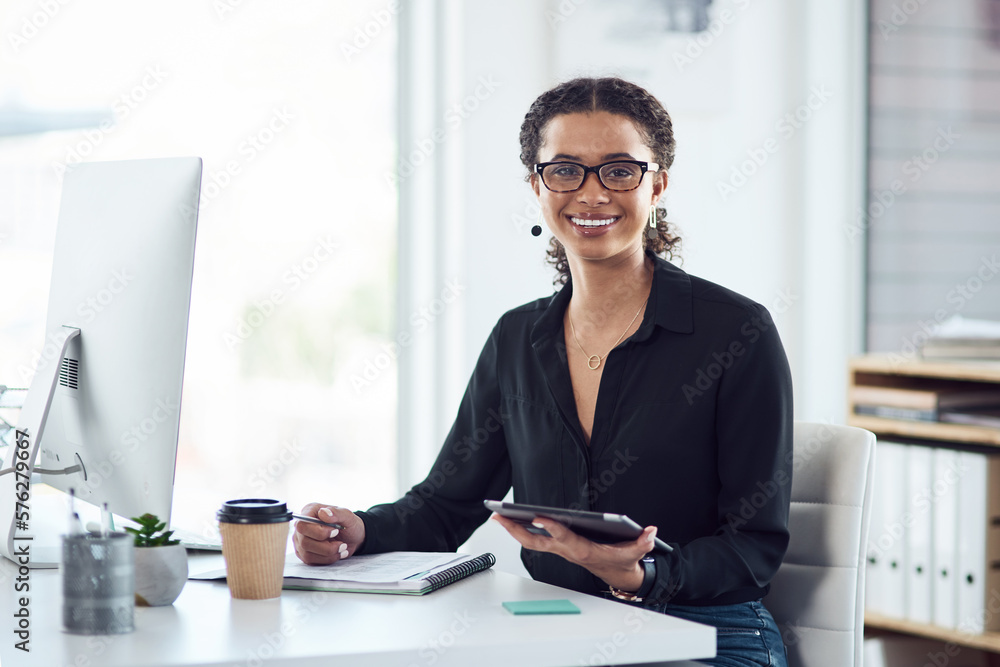 Poster staying productive is my goal. portrait of a young businesswoman writing notes while using a digital