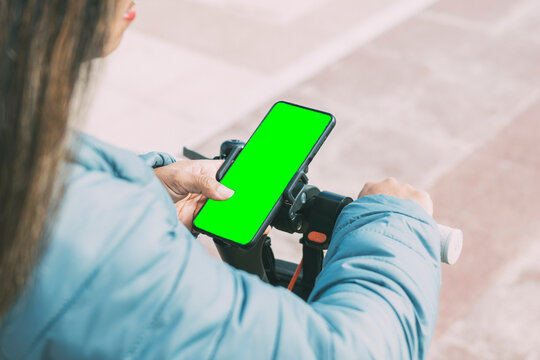 beautiful latina woman with long hair, uses smart phone application to unlock electric scooter - Powered by Adobe
