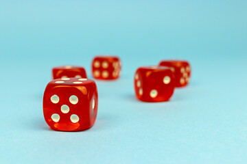 Red dice for boarding games on a blue background.