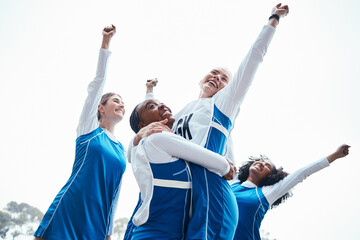 Women, friends and celebration for winning, sports team or success raising fist together in the...