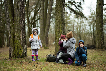 Fototapeta na wymiar Mom and children in the forest after rain together.
