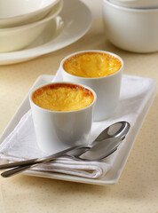 Homemade egg flan in white bowls