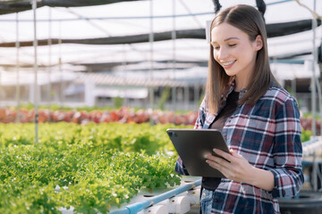 Agricultural technology farmer woman using tablet computer analyzing data.