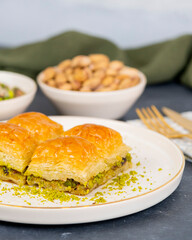 Pistachio baklava on white marble. Traditional middle eastern dessert. Turkish Antep baklava.