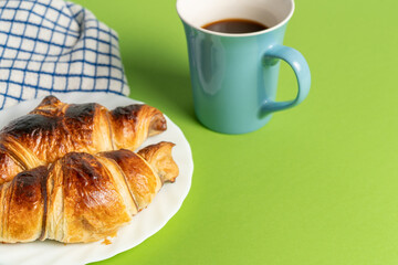 Close up of delicious chocolate croissants sprinkled with fine sugar. Sweet moment: croissants and coffee with chocolate. High quality photo