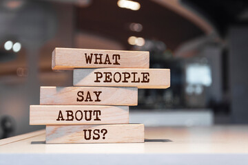 Wooden blocks with words 'What People Say About Us?'.