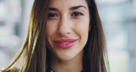 Obraz premium Beautiful, smiling and young female face feeling confident and charming. Portrait of a laughing woman head with a pretty smile, white teeth and good oral health. Closeup of a happy hispanic lady