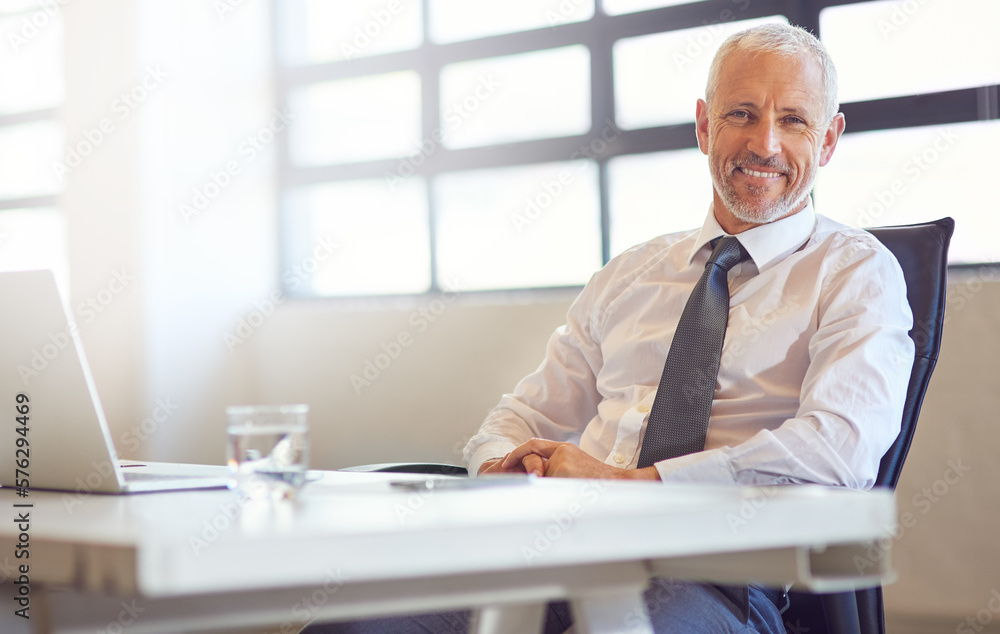 Wall mural Technology keeps me connected to my competitors. Portrait of a mature businessman sitting at his desk in an office.