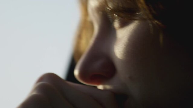 Close up girl looking out car window thinking with sad expression