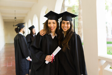 Attractive women graduates smiling feeling happy
