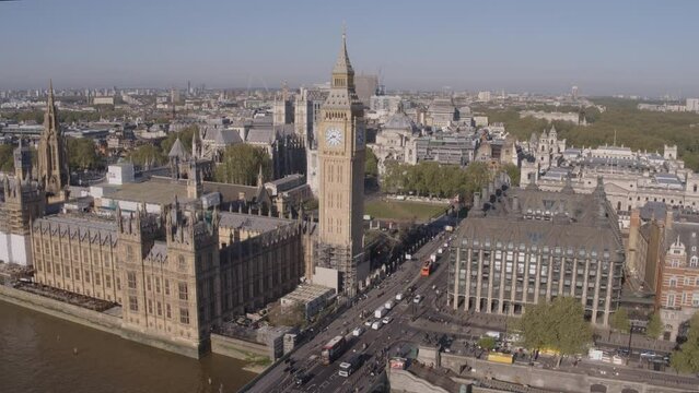 High angle aerial drone shot flying towards Westminster and Big Ben over the River Thames