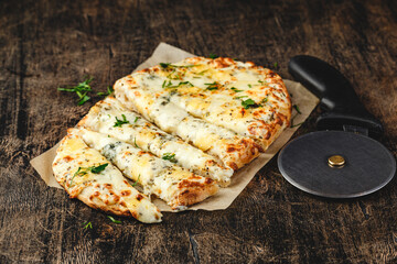 Roman-style pizzas with cheese. Roman square pizza or Pinsa on a thick dough, Italian Cuisine