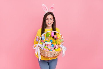 Photo of young pretty woman hold eggs stick pastry event costume isolated over pink color background