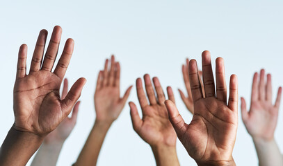 Raise your hands as one. Shot of a group of hands reaching up against a white background.