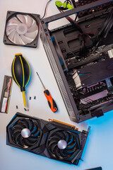 The master repairman with a brush cleans dust from the heatsink of the PC central processor cooling. Home pc maintenance