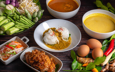 Rice noodles with fish curry sauce and spicy curry sauce, southern style with vegetables set, fried chicken, boiled egg and pickled vegetables, Thai traditional style. (Kanom Jeen Nam Ya)