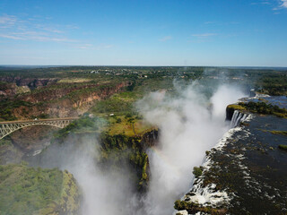 Fototapeta na wymiar Victoria Falls at the Border of Zimbabwe and Zambia in Africa. The Great Victoria Falls One of the Most Beautiful Wonders of the World. Unesco World Heritage. Aerial Shot From Above.