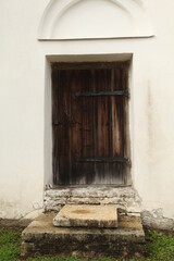 Fototapeta premium Old vintage door, enter to white construction