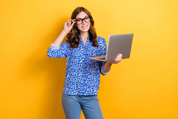 Photo of sweet adorable woman dressed blue blouse eyewear typing apple samsung gadget isolated yellow color background