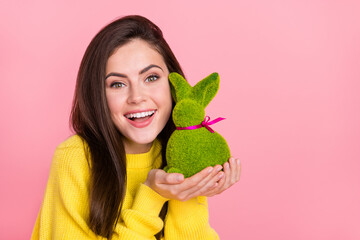 Photo of young adorable woman good mood hold bunny celebration present isolated over pink color...