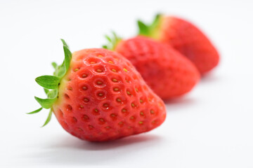 beautiful three fresh red strawberry isolated on white background
