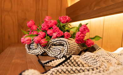 Fototapeta na wymiar Sauna accessories and bouquet of spring tulips