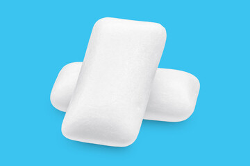 Three pieces of white chewing gum. The whole subject is in focus.