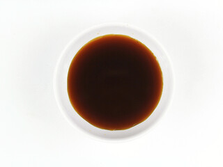 Soy sauce in a white bowl isolated on white background.