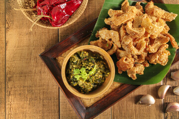 Homemade crispy pork rind with green chili paste. Local food of northern Thailand.