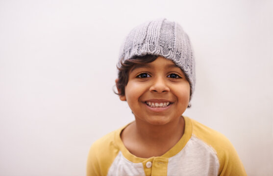 Hes growing up fast. Shot of a cute little boy wearing a beanie.
