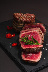 Rare cooking level Eye round steak with spices and herbs. Classic grilled meat cut ready to eat
