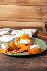 Creamy pumpkin dessert. Turkish Ramadan sweet delicacies. Pumpkin dessert with sorbet on gray background.