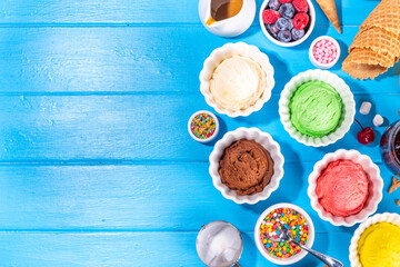 Fototapeta na wymiar Ice cream festival background, Summer ice cream buffet with various gelato sundaes flavors. sweet toppings and sprinkles, high-colored blue wooden background to view copy space