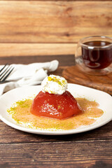 Quince dessert with sorbet on a gray background. Creamy quince dessert. Turkish Ramadan sweet delicacies