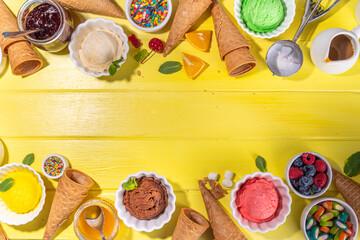 Ice cream festival background, Summer ice cream buffet with various gelato sundaes flavors. sweet toppings and sprinkles, high-colored yellow wooden background to view copy space