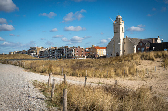 Seaside resort Katwijk aan Zee in The Netherlands, view of white church and walkways along sand dunes