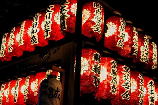 Atmospheric shot of red glowing Japanese lanterns.