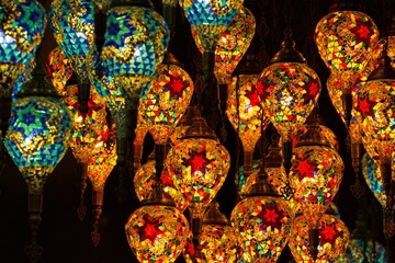 Colourful image of dozens of brightly coloured oriental mosaic lamps.