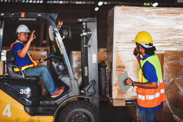 Asian male warehouse worker driving forklift for loading pallets in warehouse to container. © DJ Creative Studio